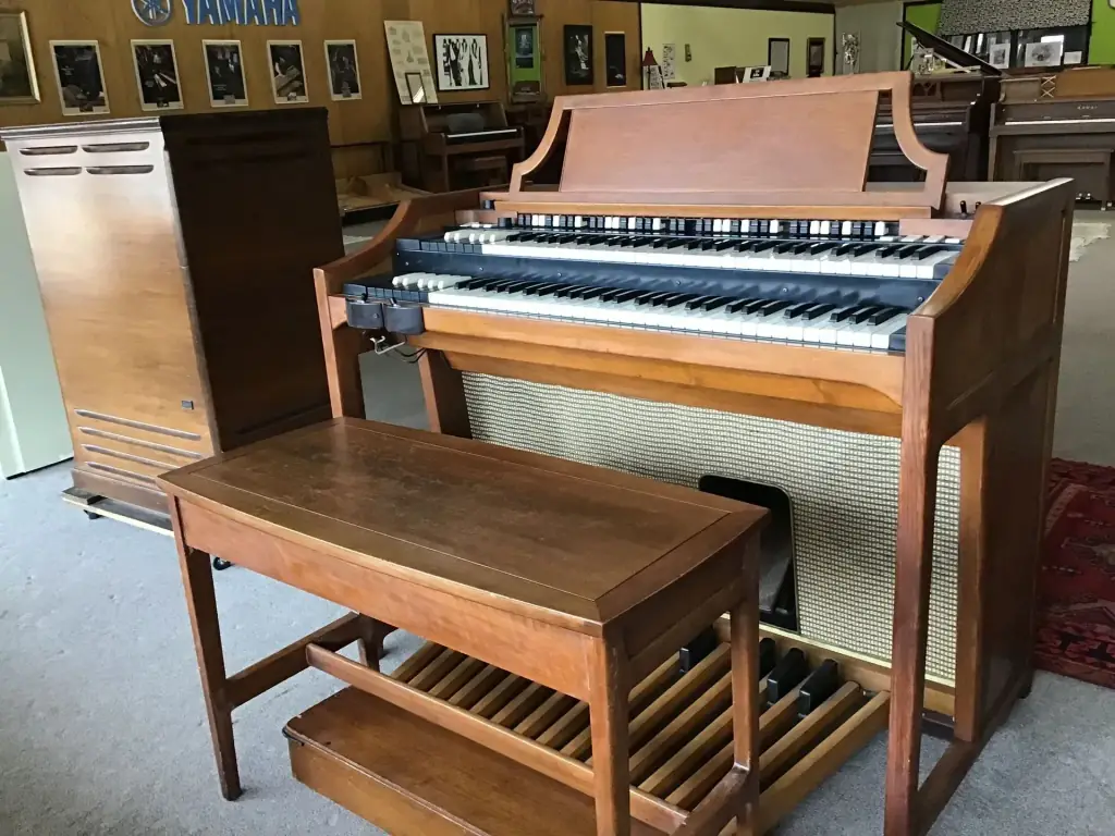 Hammond A100 console organ in cherry finish under Yamaha dealer signage